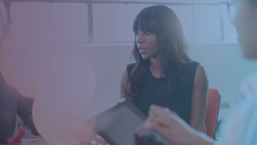 Woman sitting at conference table