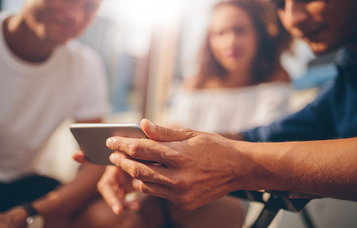 Close up of a person's hand holding a phone